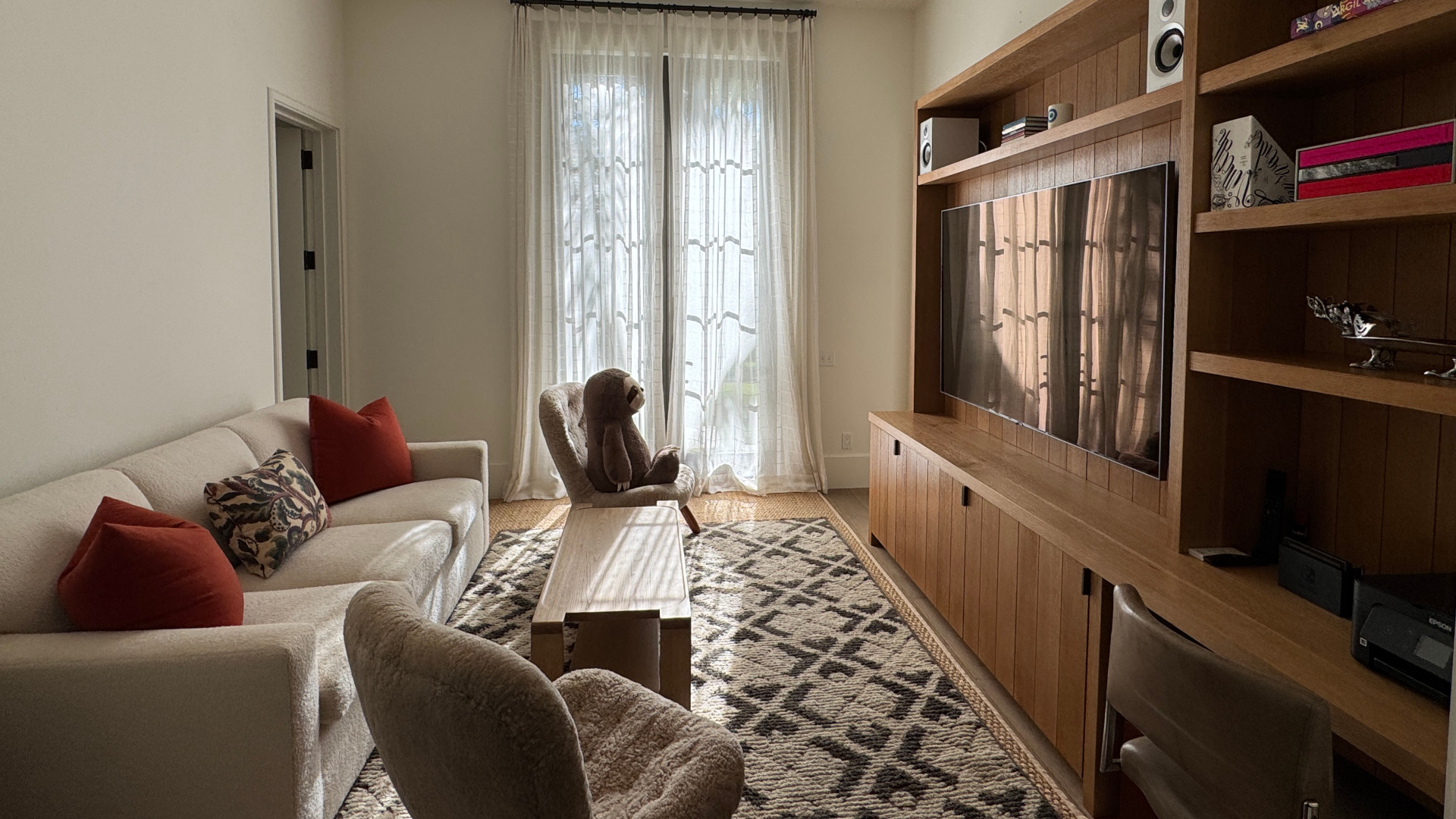 Built-in media wall with TV and speakers in a living room